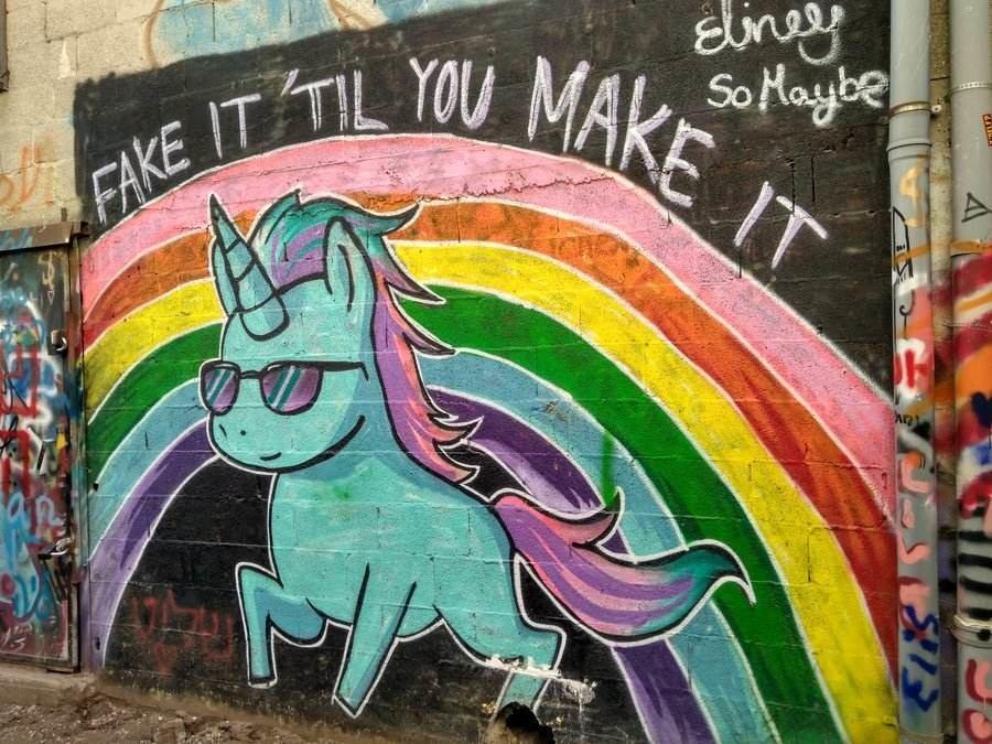 Israel: Tel Avivs Florenin neighborhood street art - unicorn graffiti. Fake it till you make it.